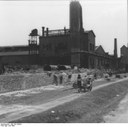 Photographer: Igel, Wiederaufbau in der DDR [Sowjetischen Besatzungszone] im Juli 1949. Blick auf das Bergmann-Borsig-Werk in Berlin-Wilhelmsruh von der Strassenseite her. Source: Bundesarchiv Bild 183-S86402 http://www.bild.bundesarchiv.de/archives/barchpic/search/?search%5Bform%5D%5BSIGNATUR%5D=Bild+183-S86402 via Wikimedia Commons https://commons.wikimedia.org/wiki/File:Bundesarchiv_Bild_183-S86402,_Berlin,_Aufbau_Bergmann-Borsig.jpg. CC-BY-SA 3.0 DE.